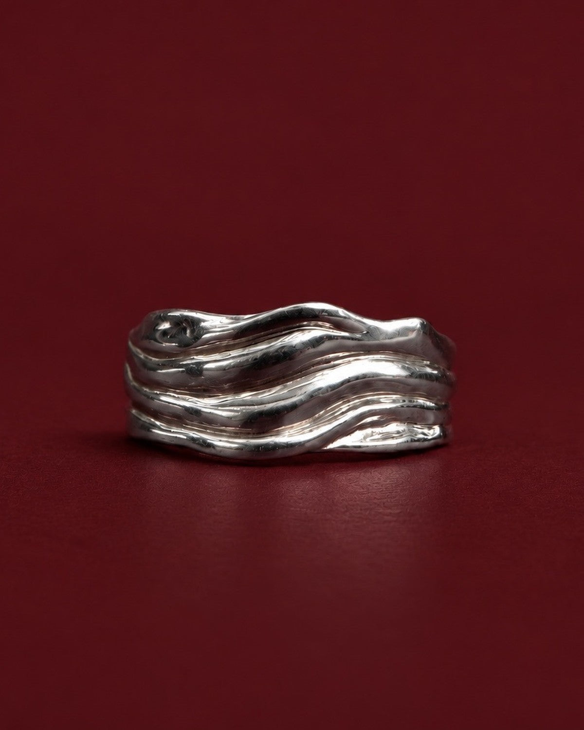 Blurr Ring in 925 recycled sterling silver on burgundy